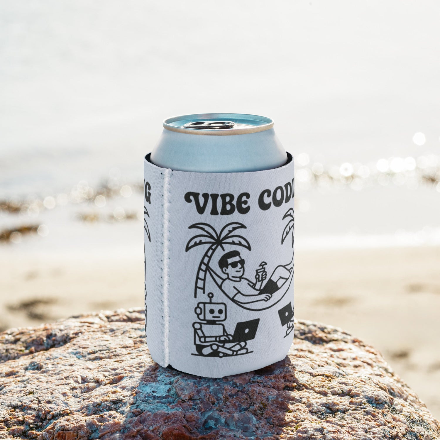 Love Vibe Coding Can Cooler on a rock by the beach